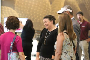 Group of faculty and staff enjoying a conversation at a networking event.