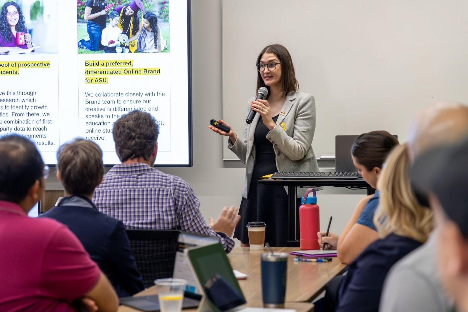 Presenter giving a talk in front of an audience of staff.